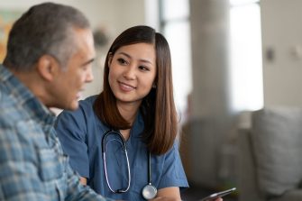 Photo of young doctor with elderly patient 