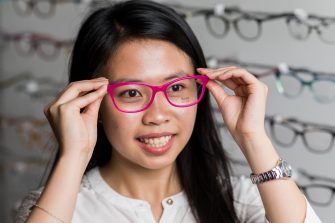 Portrate of science student holding a pair of glasses