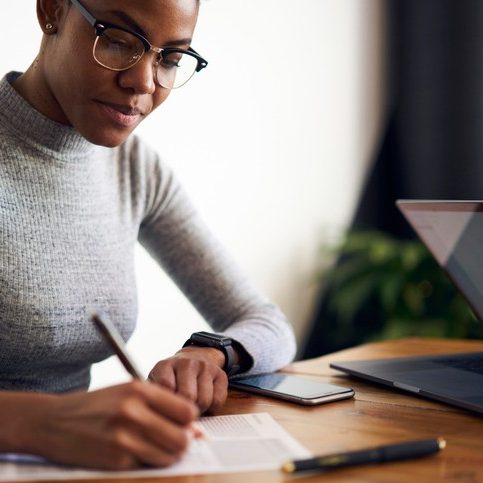 female writing paper