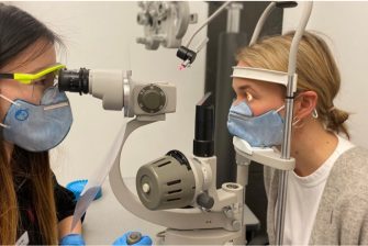 Optometry student examining a patient