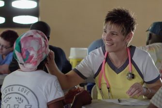 Young doctor examining patient in the field