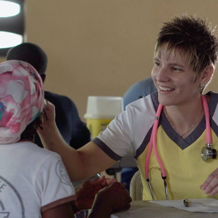 Young doctor examining patient in the field