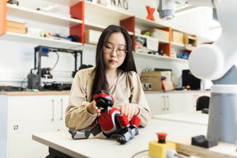 Computer Science Student working with Robotic dog in lab