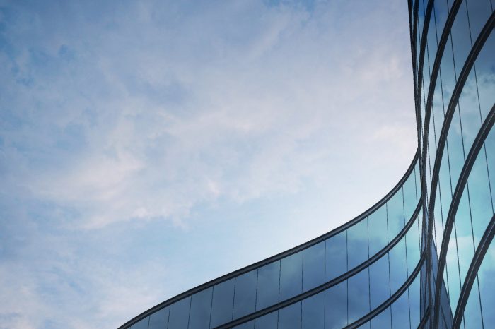 modern curved glass building adjusted for use as small business header