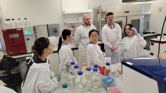 A group of researchers in a lab learning about downstream processing