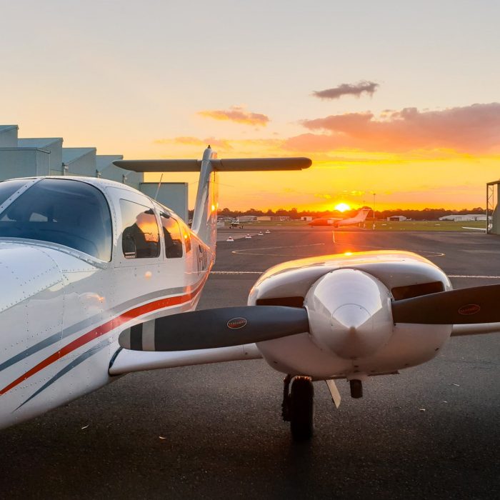 Aeroplane sitting on tarmac at sunset
