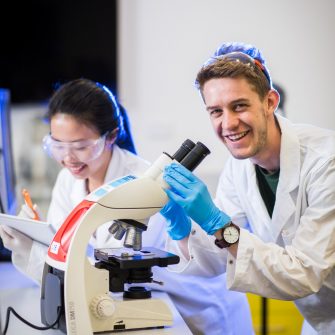Photograph of students using microscope