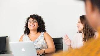 Woman in White Dress in Front of Silver Macbook