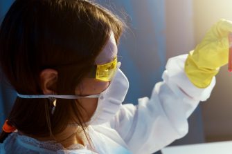 A Woman Holding While Looking at a Blood Tube