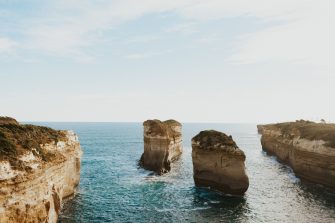 Pillars of rock formations sticking out of ocean