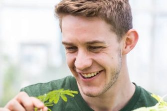 Man smiling in glasshouse