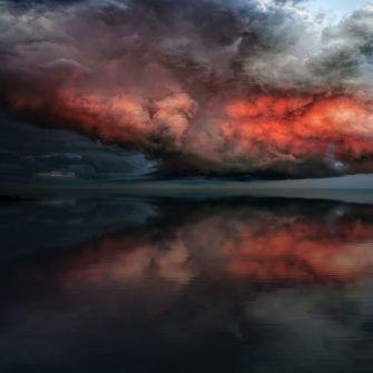 Red storm cloud over beach