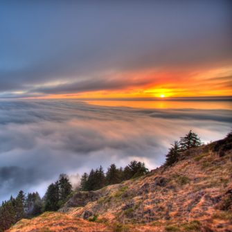 Stormy mountain sunset above clouds