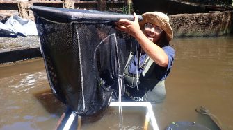 Hiruni Kammanankada holding a successful catch of fish at Ourimbah Creek
