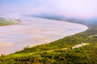 F0HAMK Amazon River aerial, with settlements and secondary rainforest, near Iquitos, Peru