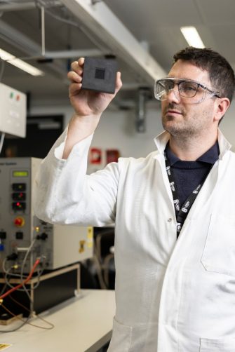 Dr Quentin Meyer in the hydrogen fuel cell laboratory in UNSW, with fuel cell tester in the background