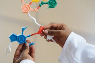 Chemist holding molecule model in hands