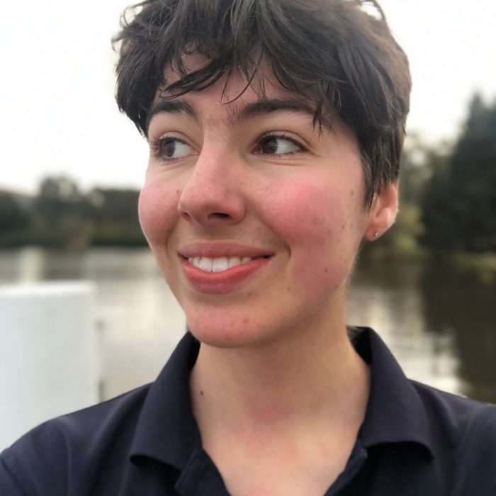 A picture of a person in front of water