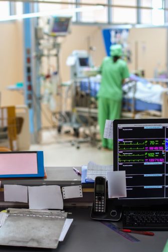 Several doctors and patients in a busy ICU