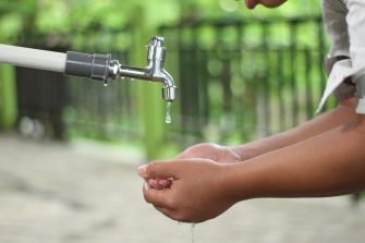 Person washing their hands at a tap