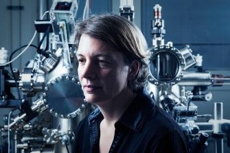 Blue-lit image of Professor Michelle Simmons in front of quantum equipment