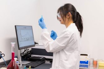 Photo of Julia Chov working in a lab as part of the UNSW Master of Industrial Research program