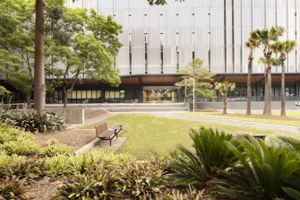 Exterior photo of the D26 building with garden beds in foreground