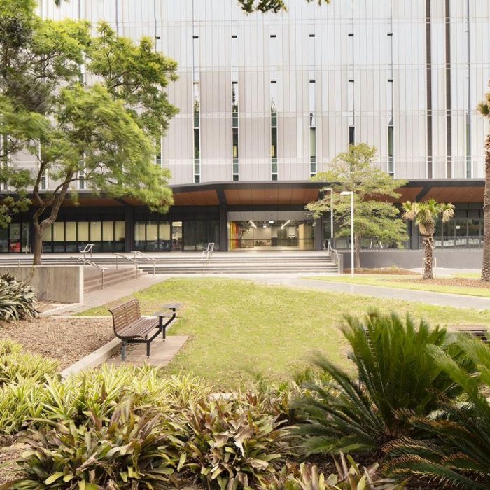 Exterior photo of the D26 building with garden beds in foreground