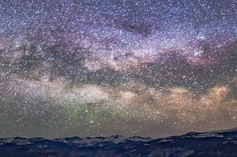 Milky way at night above rocky landscape
