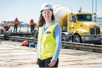 Woman wearing hard hat on construction site