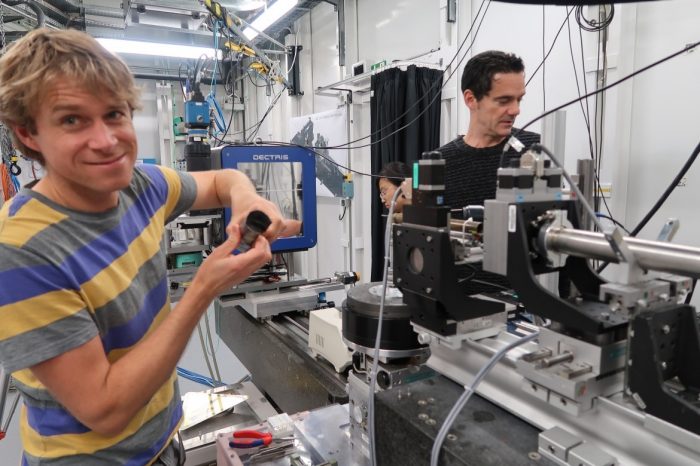 Two men working with equipment in a lab