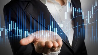 Wusiness woman in black suit with open palm hand showing stock graph