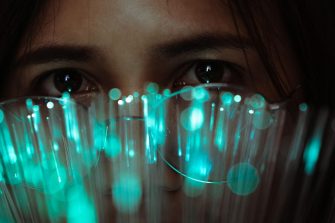 Woman looking through fibre optic lights