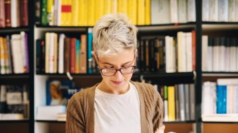 Woman with bookshelves behind her