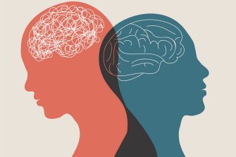 A patient sits on the couch opposite a therapist who is holding a clipboard.