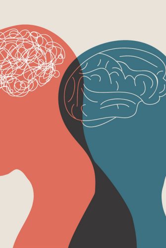 A patient sits on the couch opposite a therapist who is holding a clipboard.