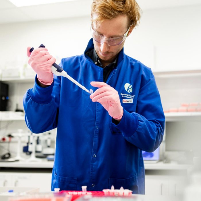 Research assistant pipetting in lab