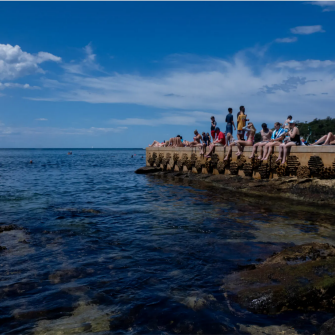 People sunbathing on beach pier