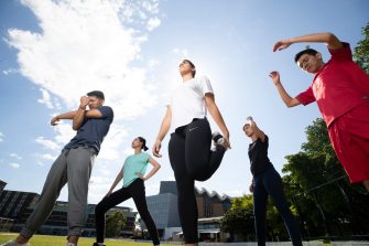 Students stretching on Village Green