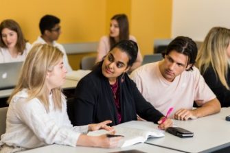 Photo of students partnering with each other on a project