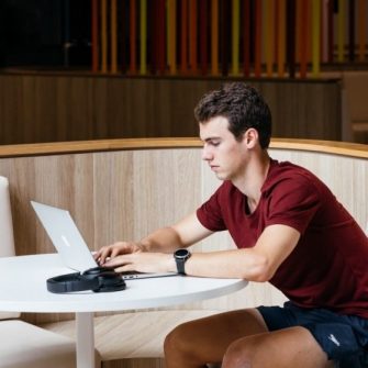 Photo of student using laptop on campus