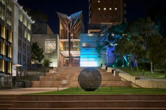 UNSW Kensington campus with coloured lighting to acknowlegde Naidoc week.