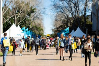 Photograph of potential students socialising and browsing the UNSW campus