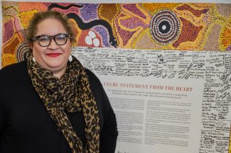 Magan Davis stands in front of The Statement from the heart document