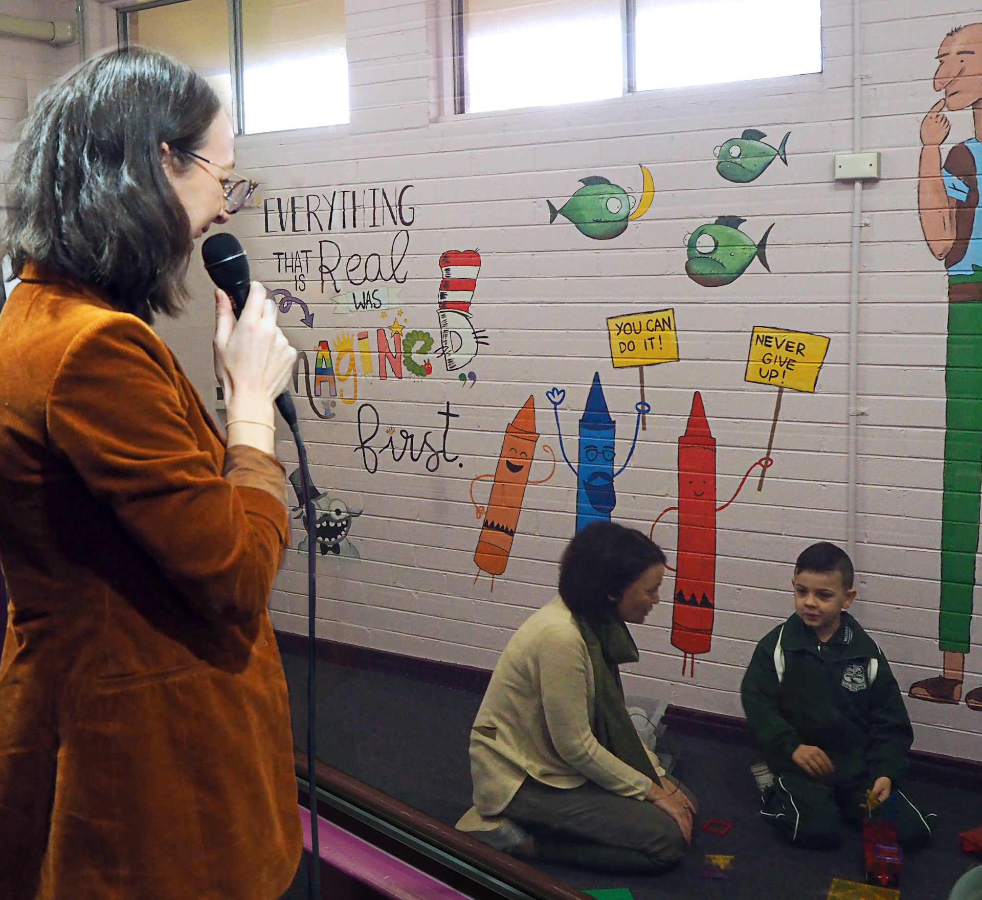 Dr Georgie Fleming stands behind a one-way mirror to coach a parent interacting with her child. Photo: UNSW