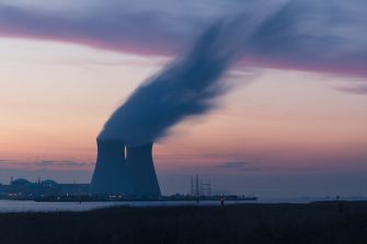 Two nuclear power plant stacks billow smoke into the air