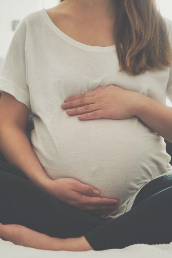Pregnant woman touching her belly