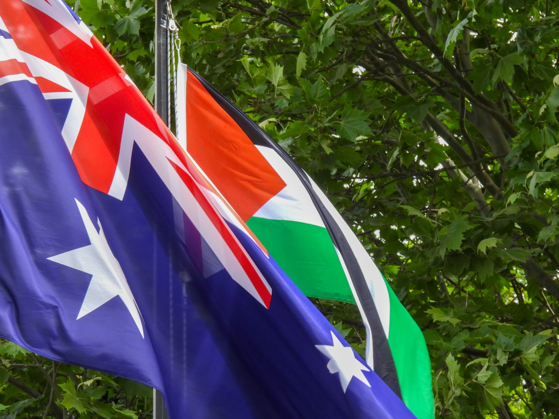 Palestinian Flag and Australian flag move in the breeze beside one another