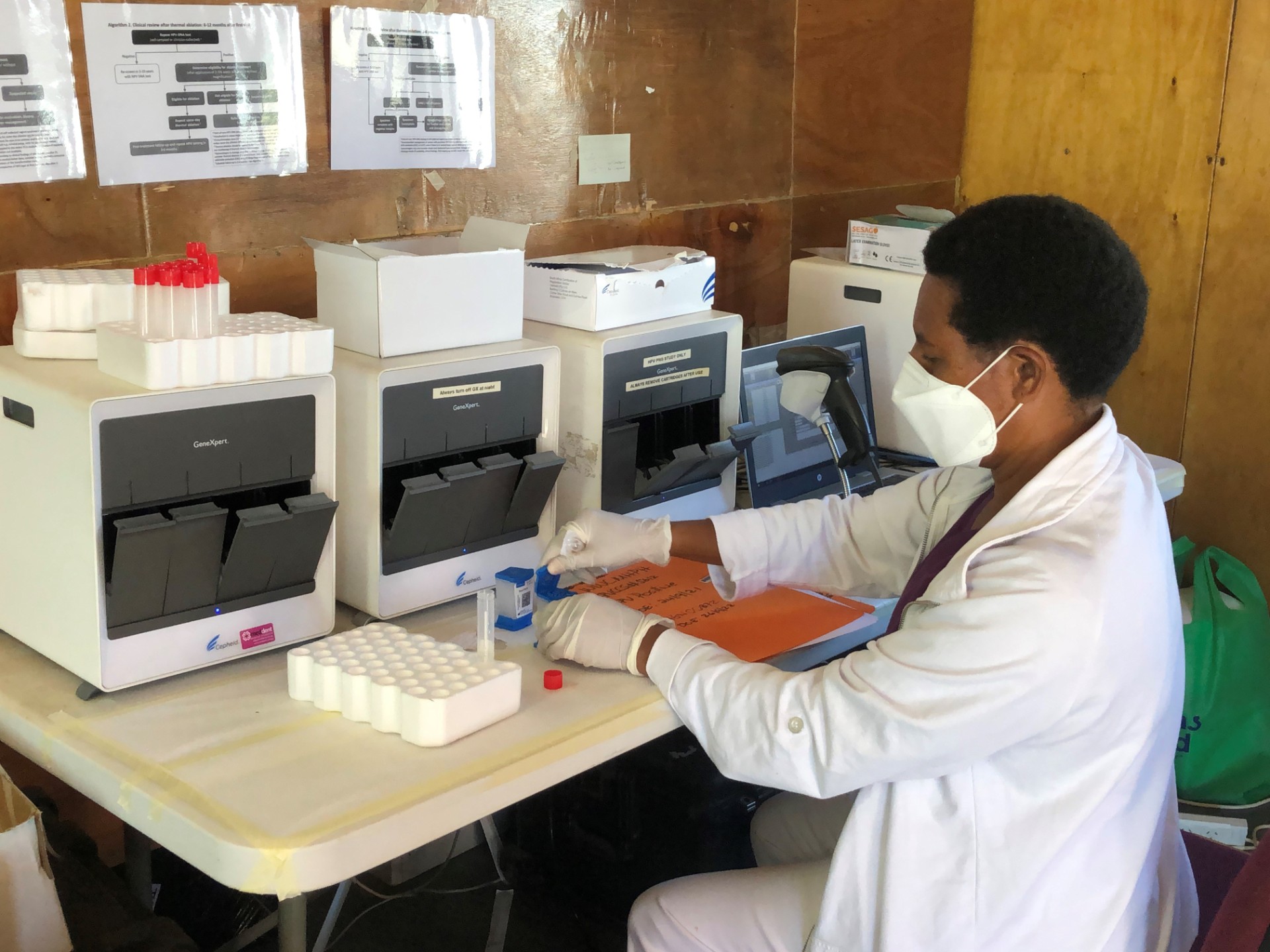 A woman holding a sample in a medical clinic.