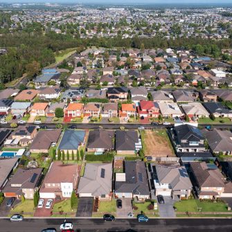 Aerial view of rows of typical homes built during the 2010s in outer suburban Sydney, Australia.